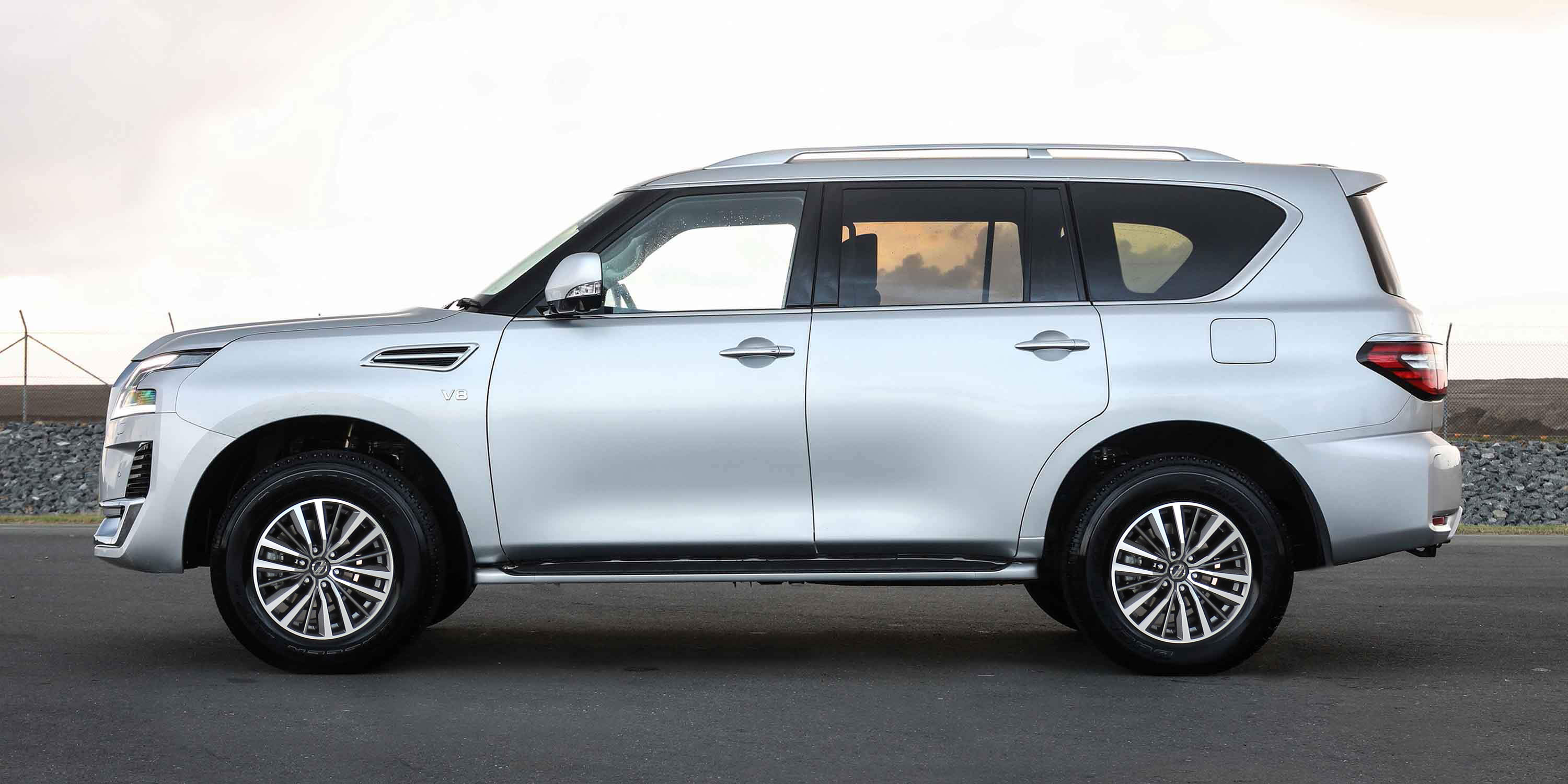 Nissan Patrol on road during sunset